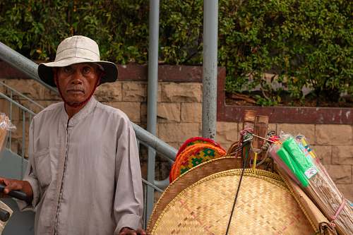 person man in grey long-sleeved shirt standing beside grey metal stair railings people