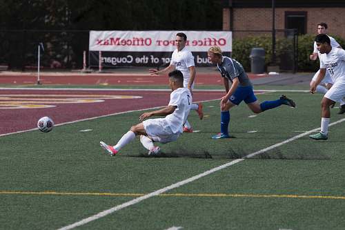 football man near soccer ball on turf soccer