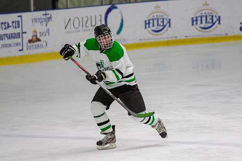 person man playing ice hockey inside court apparel