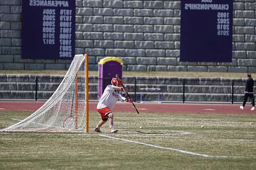 person man playing lacrosse at the field people