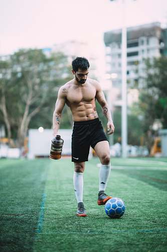 person man playing soccer ball during daytime mumbai