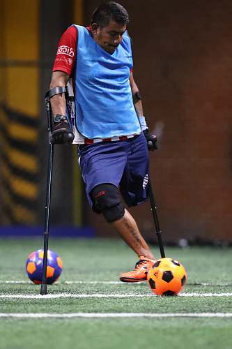 apparel man playing soccer during daytime clothing