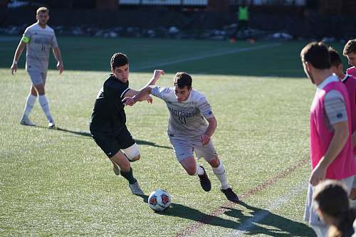 person man playing soccer on the field people