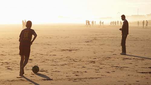 person man playing soccer nature