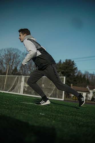 person man running on field during daytime field