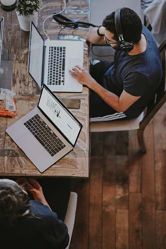 person man sitting on chair and looking laptop computer people