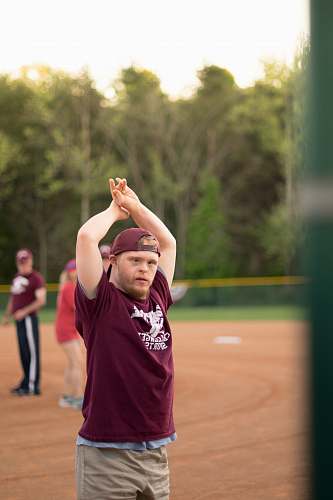 person man standing and raising his both hands clothing