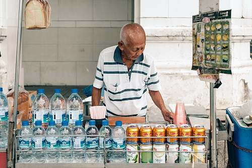bottle man standing in stall drink