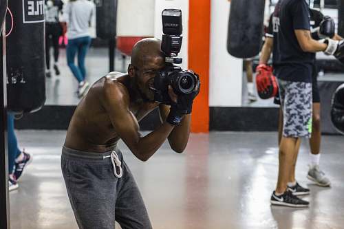 person man taking picture while using DSLR camera shoe