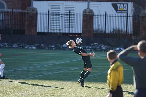 person man trying to bounce the soccer ball on his chest people