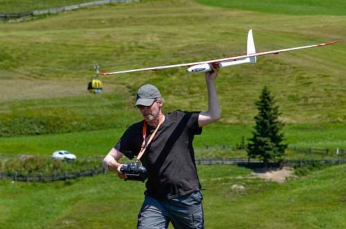 person man walking and holding RC plane toy ball