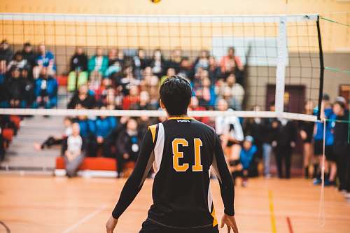 person man wearing black 13 volleyball jersey people