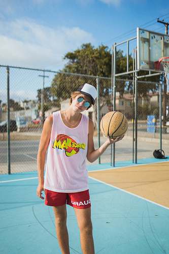 person man wearing white tank top and red shorts accessories