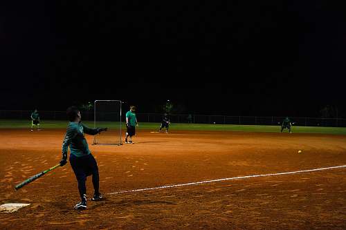 person men playing baseball during nighttime people