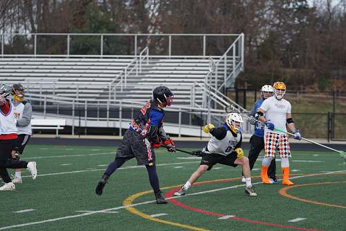 person men playing lacrosse on field apparel