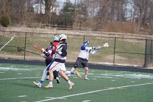 person men playing lacrosse sports during daytime apparel