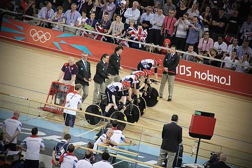person men riding bicycles on starting line at track people