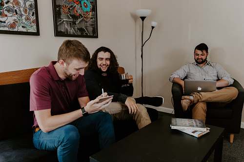 person men sitting on sofa people