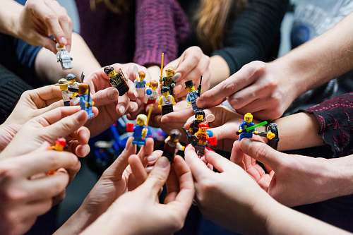 person people holding miniature figures finger