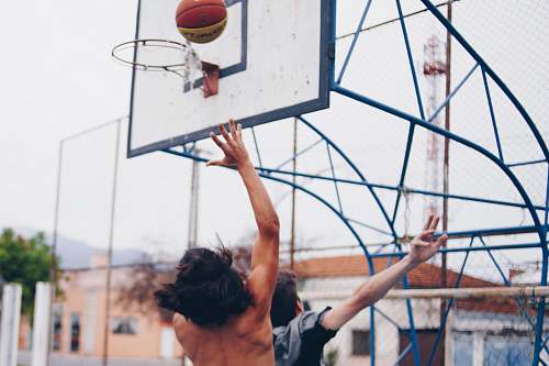 person people playing basketball during daytime people