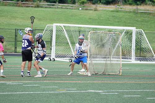 person people playing lacrosse during daytime people