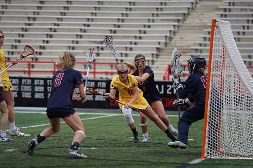 person people playing lacrosse stick on field apparel