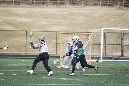 person people playing on field during daytime apparel