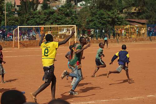 person people running on soccer field during daytime sport