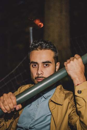 banister person holding black metal tube handrail