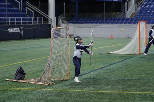 person person holding lacrosse stick in field people