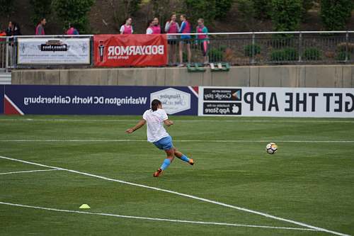 person person playing soccer on field people