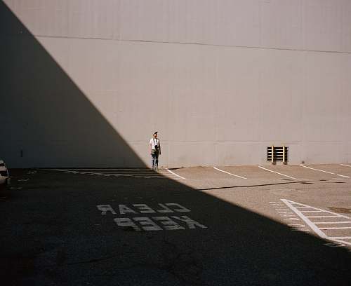 person person standing against wall asphalt