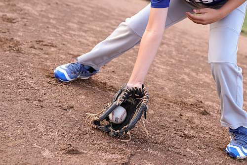 apparel person wearing black leather baseball mitt catching baseball clothing