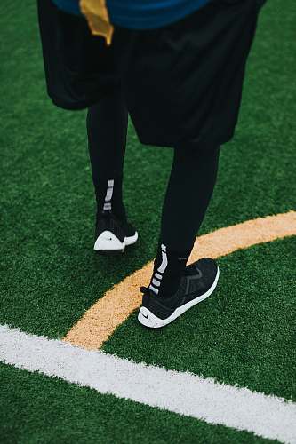 apparel person wearing black Nike shoes clothing
