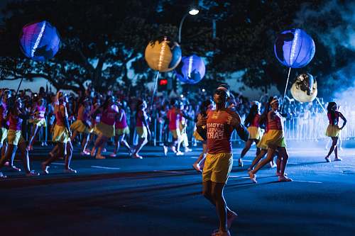 person selective focus photography of people dancing on street at night apparel