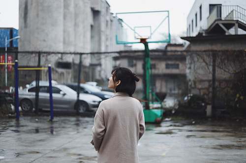 person selective focus photography of woman standing near basketball hoop apparel