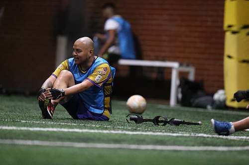 person shallow focus photo of man in blue and yellow T-shirt people