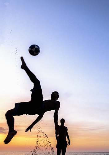 person silhouette photography of person playing soccer sphere