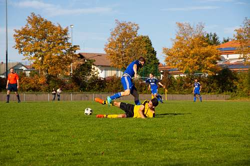 person soccer play photo during daytime people