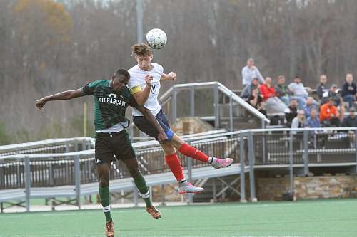 person soccer players jumping people