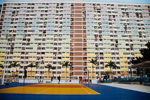 person tennis court in front of building during day building