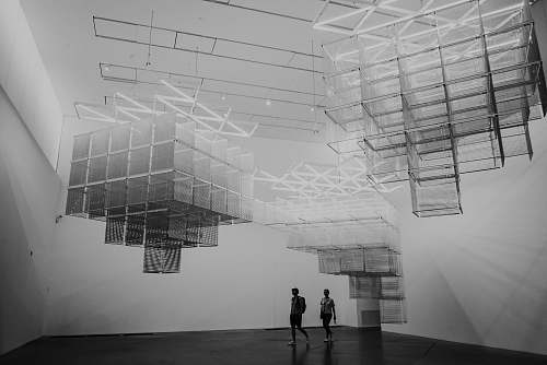 black-and-white two person walking inside room grey