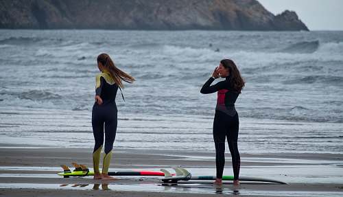 person two woman standing on sea shore fitness