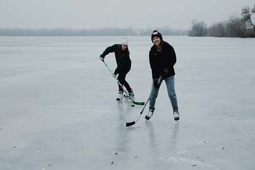 person two women playing ice hockey shoe