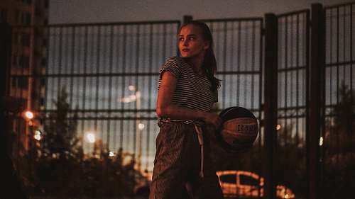 person woman holding a black and white basketball ball people