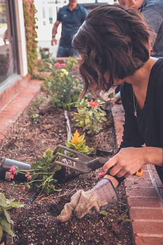 outdoors woman holding garden fork garden