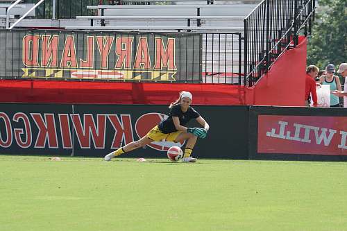person woman in black shirt about to catch a ball during daytime people