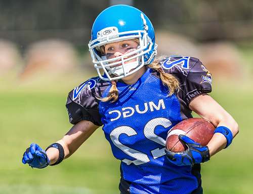 team woman in blue helmet playing football helmet