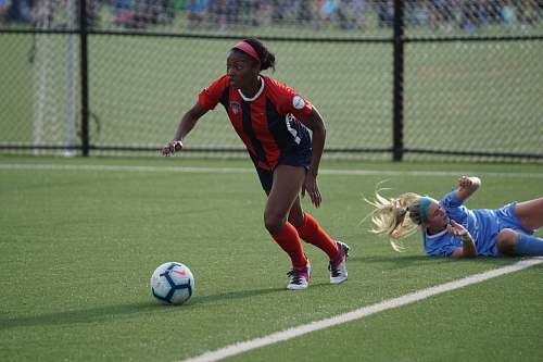 person woman in red jersey kicking the ball people