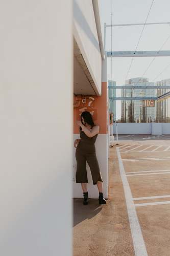 person woman leaning on wall flooring